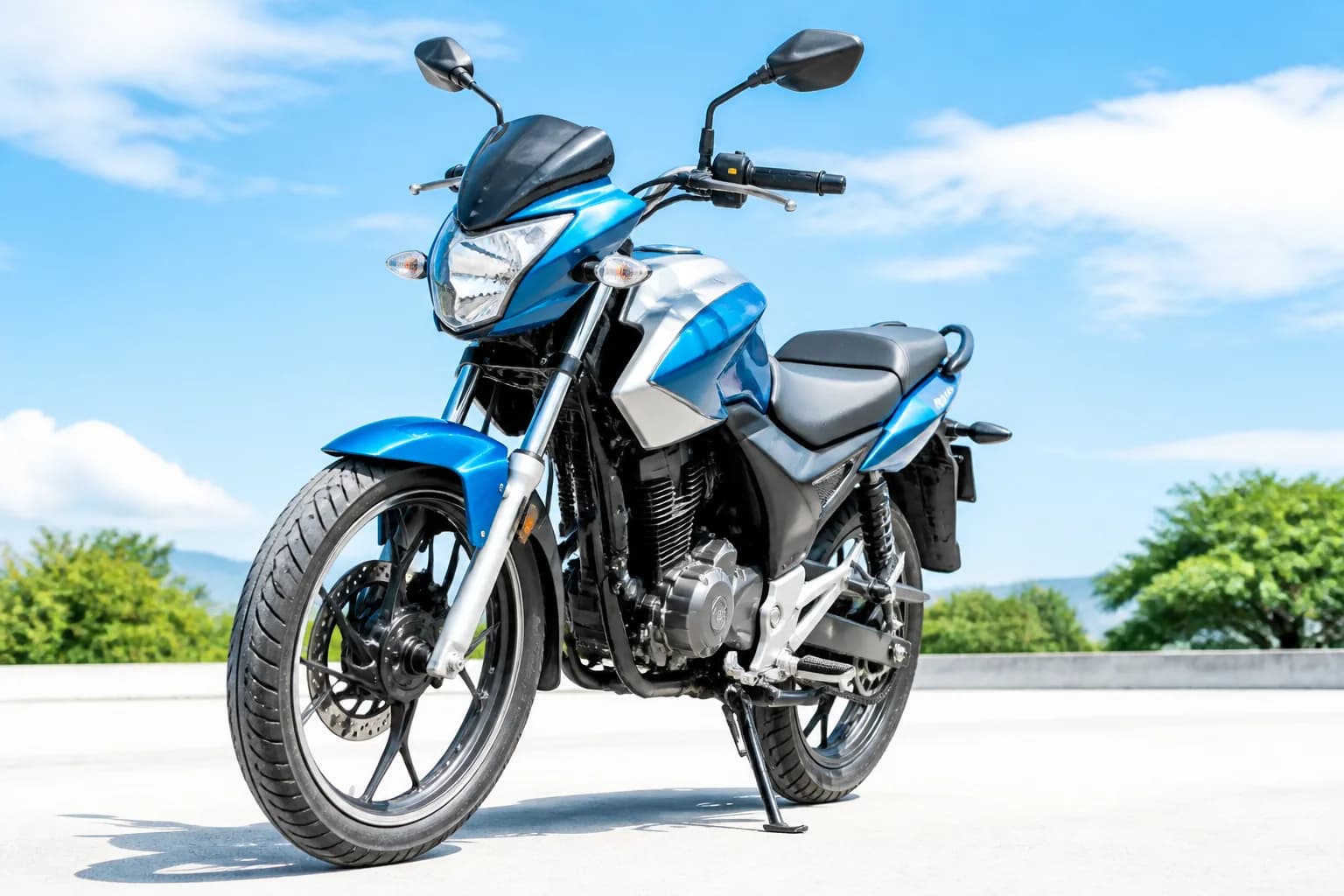 Sport commuter motorcycle lit dramatically in a dark studio