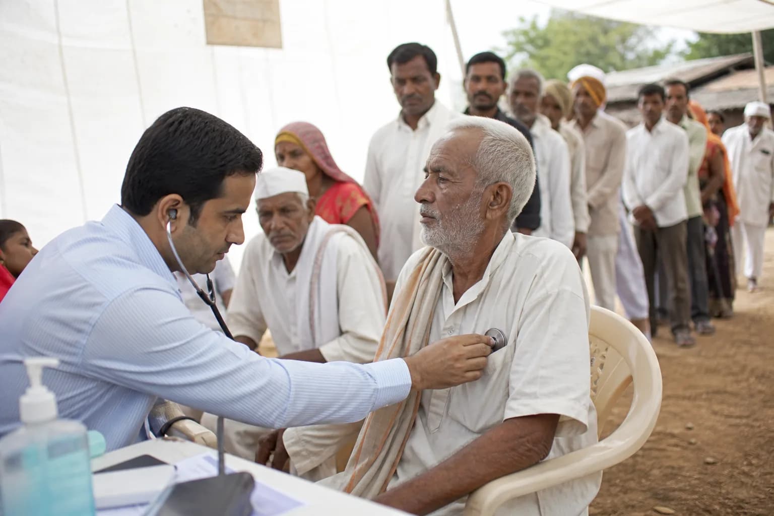 A doctor examining a villager at a free rural health camp